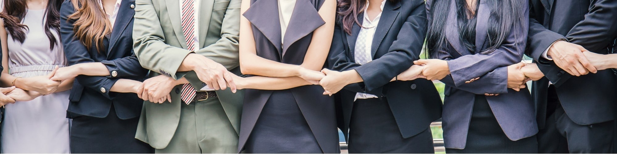 Business people holding hands